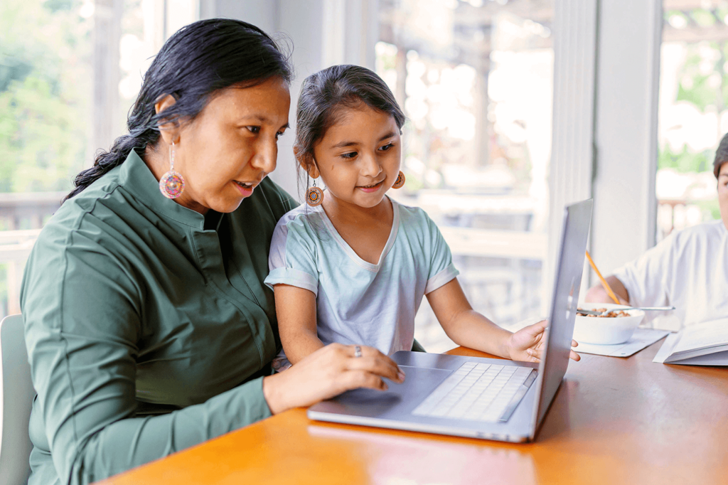 Mom and child looking at a laptop